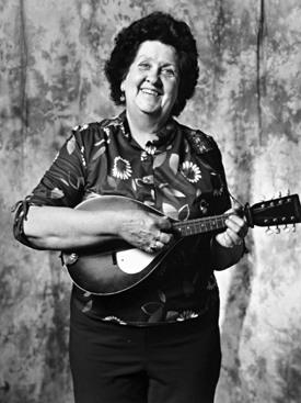 Rita Maloney: What drew me to country music is that my husband and I wanted something to do when we retired. I started playing the chord organ then the ukulele. I’ve been playing the mandolin for several years and I also play the banjo, sing and yodel.