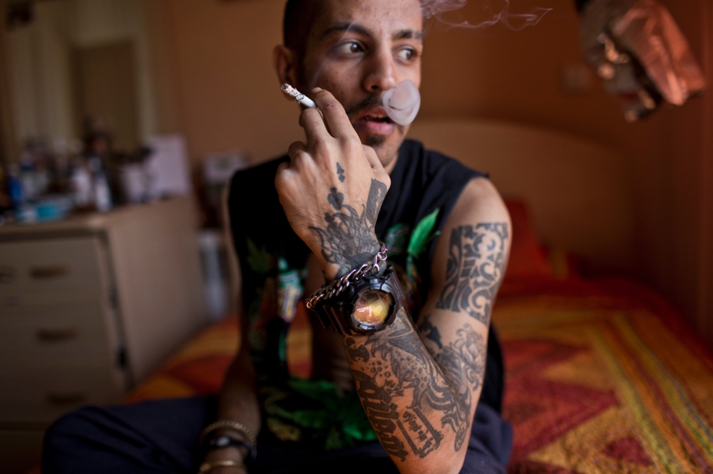 Iran, Tehran, Siavash, a tattooist, smokes a cigarette. While not illegal, Islamic law is often used to denouce those sporting them.