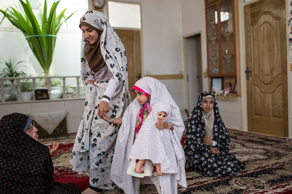 Iran, Yazd, The female members of a family at their home where even the youngest girl wears a chador.
