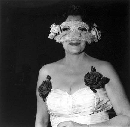 Lady at a masked ball with two roses on her dress, N.Y.C.