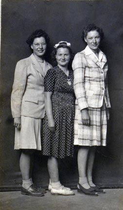 Untitled (three women standing close together)