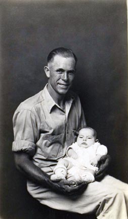Untitled (man holding infant on lap)