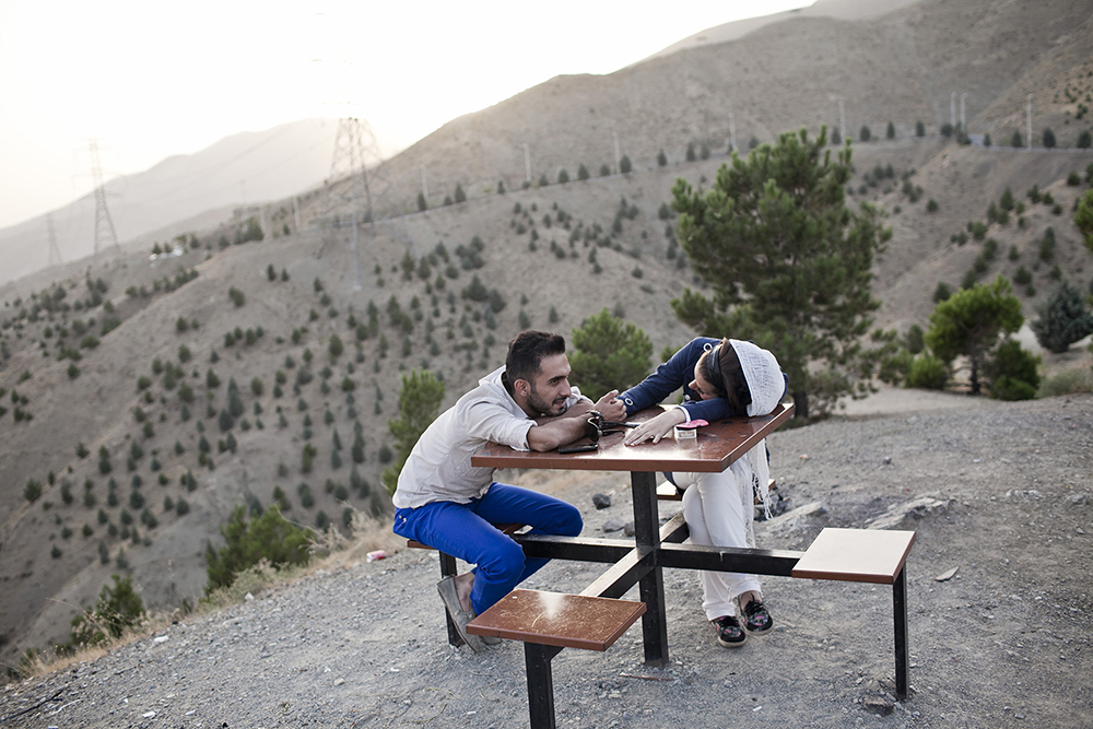 Tehran, Iran. A couple talking in the privacy of Bam-eTehran, the 'roof of Tehran.’