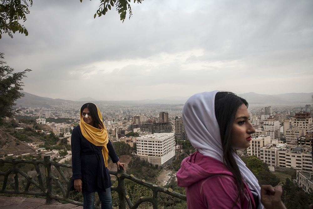 Tehran, Iran. A group of young women stand on a terrace at Bam-e Tehran, the 'roof of Tehran,' an area overlooking the capital. One of the young women has a dressing on her nose following plastic surgery. Iran has the highest rate of nose surgery in the world with a reported 200,000 operations taking place each year.