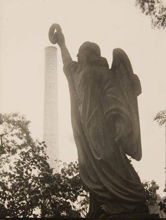 Untitled (angel sculpture holding up wreath)