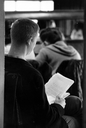 Untitled (young man reading notes in school)