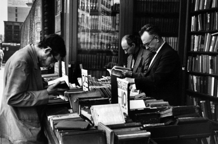Fourth Avenue, New York (men reading at outdoor book stall)