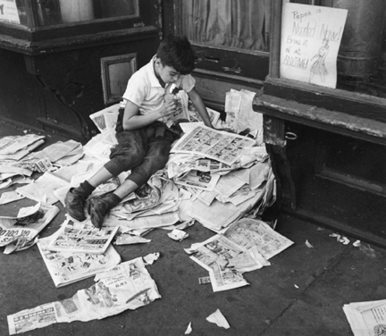 New York (boy eating ice cream on pile of newspapers)