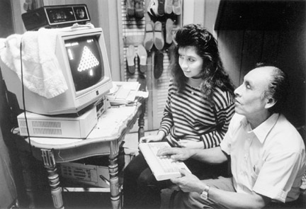 Mr. Rodriguez and Daughter Play Computer Games in Sons Bedroom