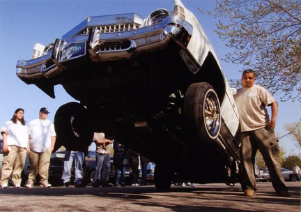 Pete Hernandez Straightens the Wheels of his Chevrolet as his Car Hops Nearly 35 Inches Off the Street at La Baugh Woods Near Foster and Cicero in Chicago, May 2003